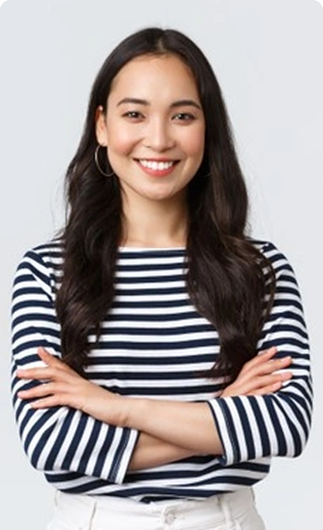Smiling young woman with hands folded politely